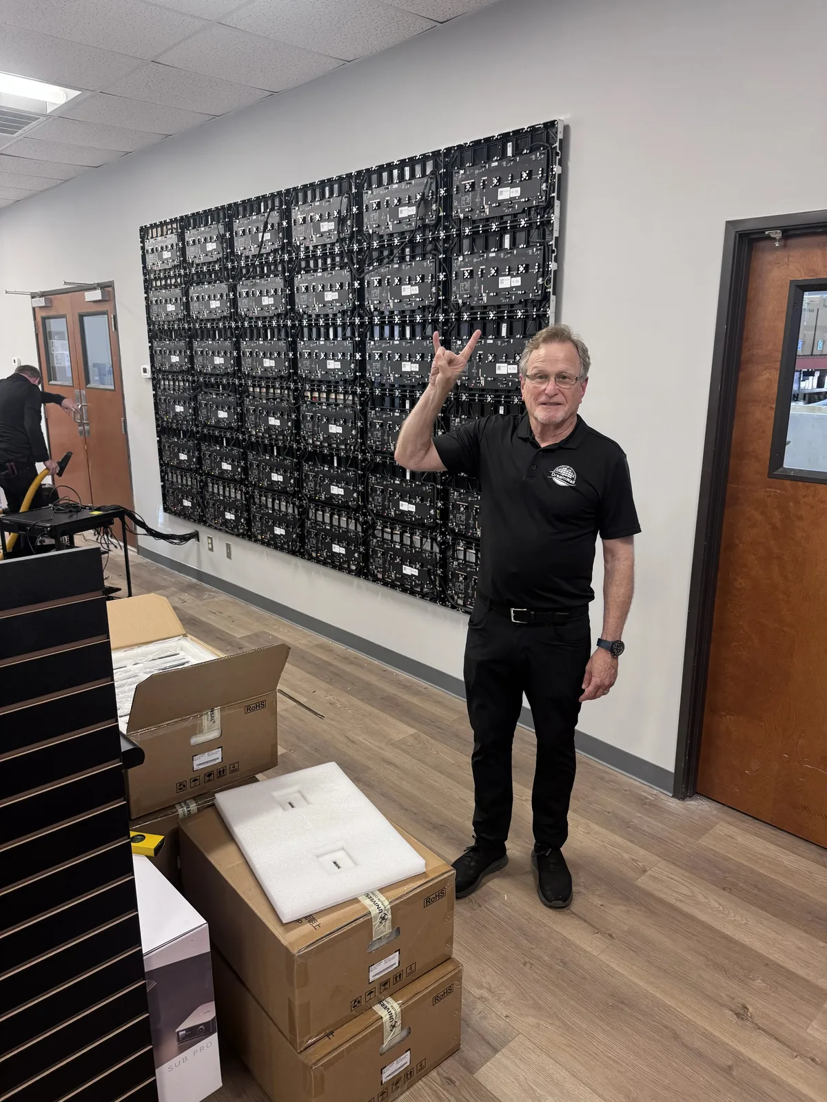 Gary Wermuth standing beside an LED video wall installation