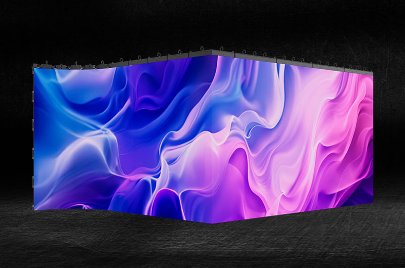 A curved Absen LED video wall displaying flowing blue and pink abstract imagery in a dark studio