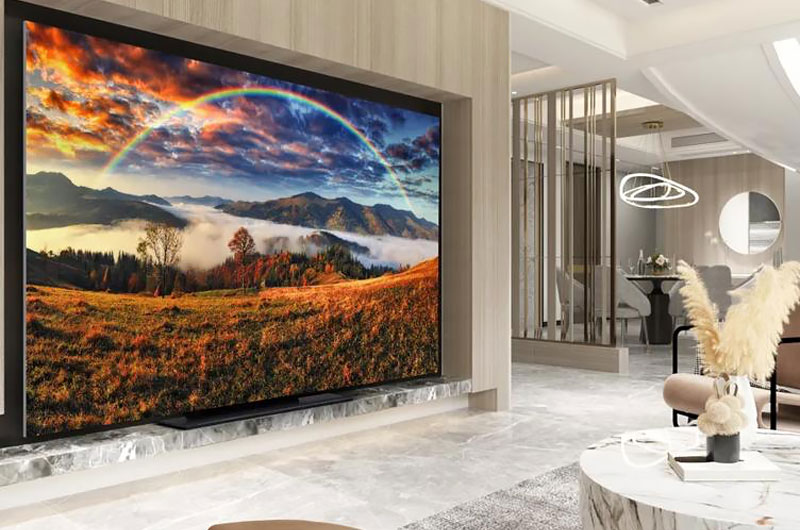 An LG MAGNIT MicroLED video wall displaying a mountain landscape with a rainbow in a luxury living space
